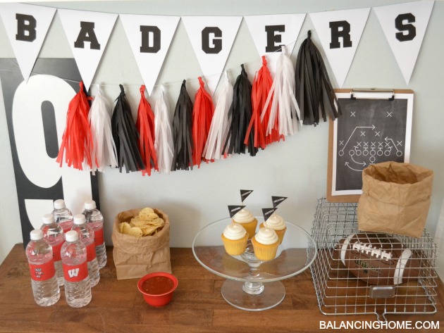 Football Party with lots of printables: Chalkboard playbook printable, varsity letter pennant printable, cupcake topper printables. Simple tips for entertaining like paper bag serving bowls, customized water bottles, and DIY tassel bunting.